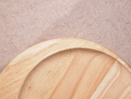 Wood plate on fabric backgroundの写真素材