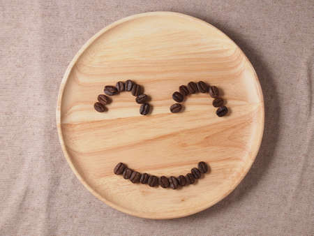 Coffee crop beans on wood texture backgroundの写真素材