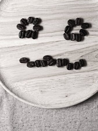 Coffee crop beans on wood texture, monotone color backgroundの写真素材