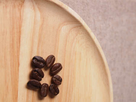 Coffee crop beans on wood texture backgroundの写真素材