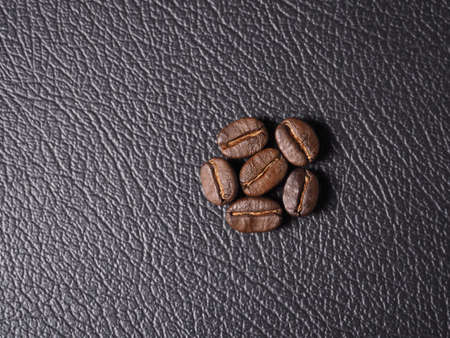 Coffee crop beans on leather texture backgroundの写真素材