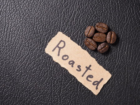 Coffee crop beans on leather texture backgroundの写真素材