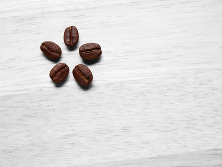 Coffee crop beans on wood texture background