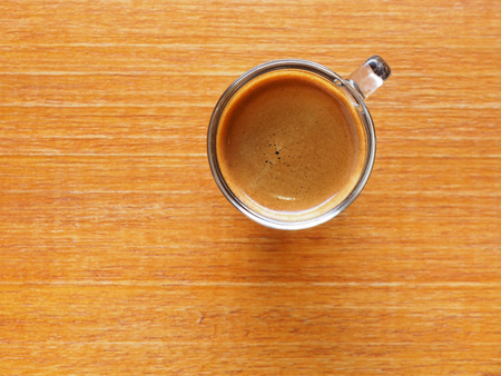 Cup of hot espresso coffee on wooden tableの写真素材