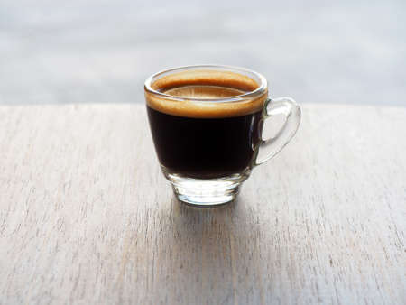 Cup of hot espresso coffee on wooden tableの写真素材