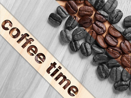 Coffee crop beans on wood texture with coffee text backgroundの写真素材