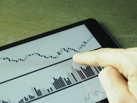 Smartphone Tablet with stock chart investment on screenの写真素材