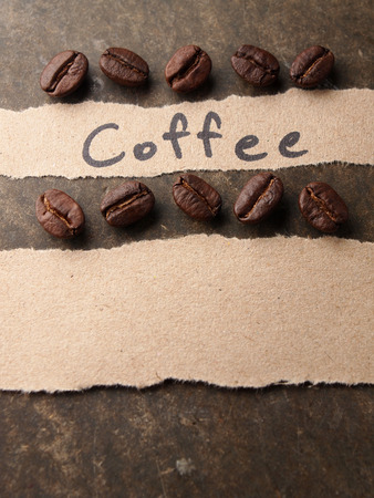 Coffee crop beans with paper on wood texture backgroundの写真素材