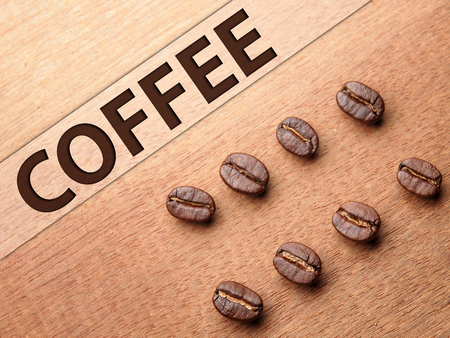 Coffee crop beans on wood texture backgroundの写真素材