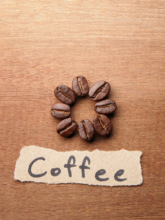 Coffee crop beans with text paper on wood texture backgroundの写真素材