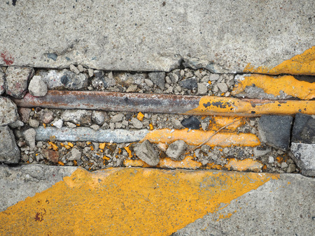 crack concrete floor with corroded pipe texture backgroundの写真素材