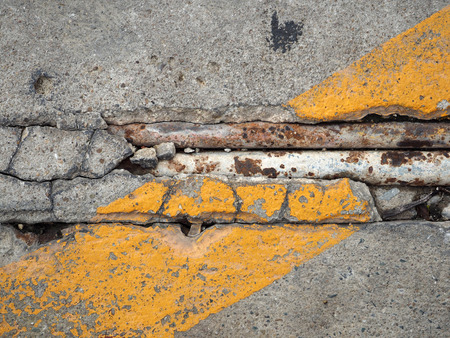 crack concrete floor with corroded pipe texture backgroundの写真素材