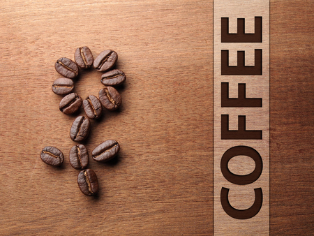 Coffee crop beans on wood texture backgroundの写真素材