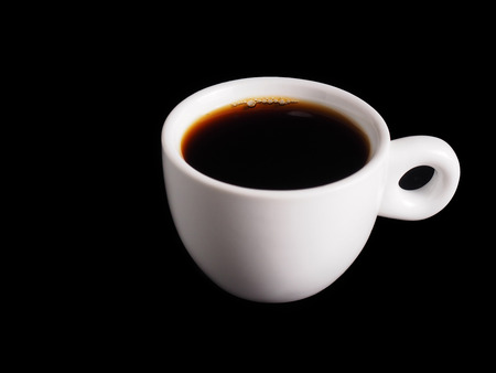 White Cup of hot black coffee on table with black backgroundの写真素材