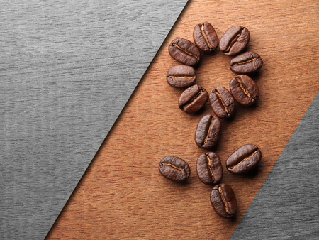 Coffee crop beans on wood texture backgroundの写真素材