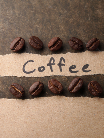 Coffee crop beans with paper on wood texture backgroundの写真素材