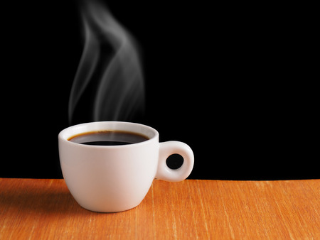 White Cup of hot black coffee on table with black backgroundの写真素材
