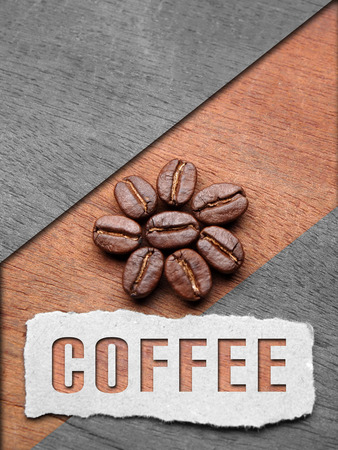 Coffee crop beans on wood texture with coffee text backgroundの写真素材