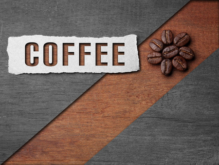 Coffee crop beans with paper and coffee text on wood texture backgroundの写真素材