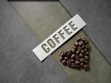 Coffee crop beans on wood texture with coffee text backgroundの写真素材