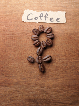 Coffee crop beans with text paper on wood texture backgroundの写真素材