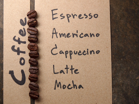 Coffee crop beans with paper on wood texture backgroundの写真素材