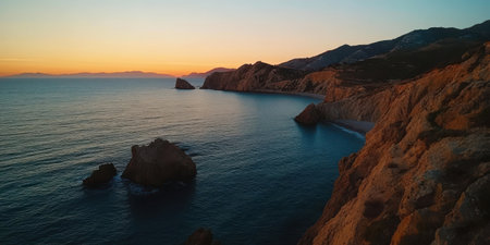 Panoramic view of iconic red cliffs and sea stacks framing a serene turquoise cove at golden hour sunset along Portugal's Algarve coast. Ideal for travel agency ads, resort websites, and adventure tourism campaigns evoking wanderlust and natural beauty.の素材