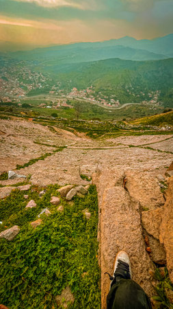 High-resolution capture with sharp details, vivid sunset colors, and dramatic lighting highlights the rugged stone terraces, lush greenery, and distant mountains.の写真素材