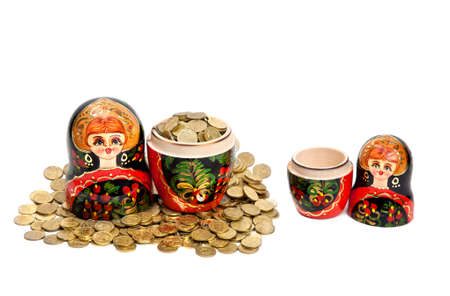 Two Matryoshkas. One Matryoshka is full of coins and another is empty at white backgroundの写真素材