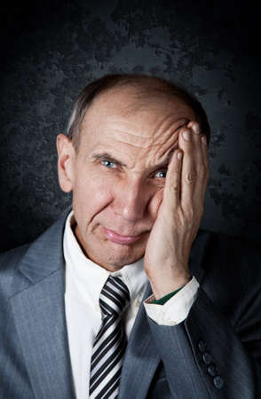 Businessman in frustration at grunge backgroundの写真素材