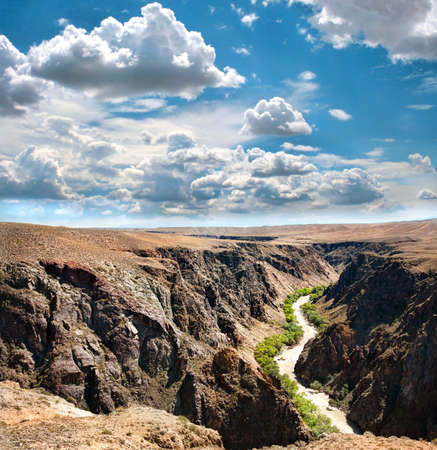 Beautiful river in Charyn canyon and blue sky with clouds in Kazakhstan Beautiful river in Charyn canyon and blue sky with clouds in Kazakhstan