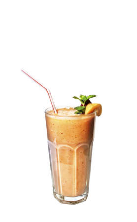 Glass of peach milk cocktail decorated with slice of apricot, mint and stick at white background 