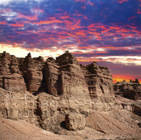 Charyn grand canyon in Kazakhstan at sunset dramatic sky background in purple, red and blue colorsの写真素材