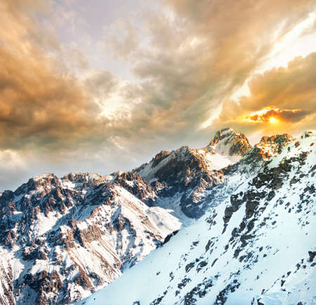 View to the Peak Komsomol in Winter Snowy Mountains from Kumbel mountain at sunset in Almaty,...