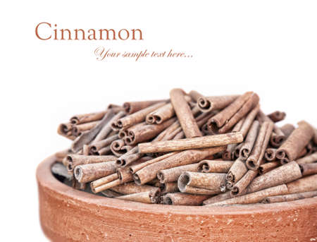 Cinnamon spice heap in bowl isolated on white background. の写真素材