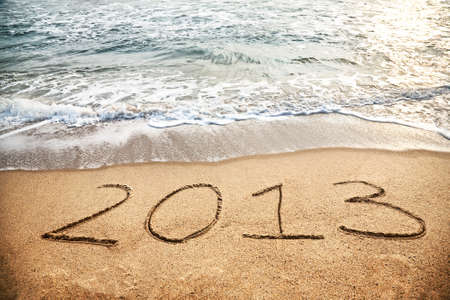 2013 year on the sand beach near the oceanの写真素材