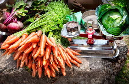 Carrots with leaves and beetroots near Cabbage on scales at the market, Kumly, Kerala, India の写真素材