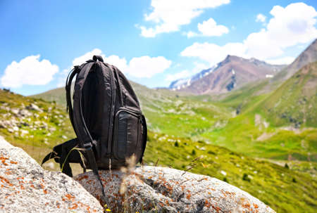 Black backpack on the stone in mountains in Kazakhstan, central Asiaの写真素材
