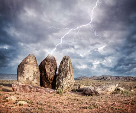 Lightning strikes three big stones in the steppe of Kazakhstan, central Asia の写真素材