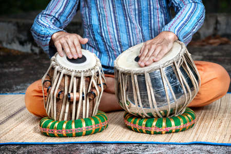 Man playing on traditional Indian tabla drums close upの写真素材