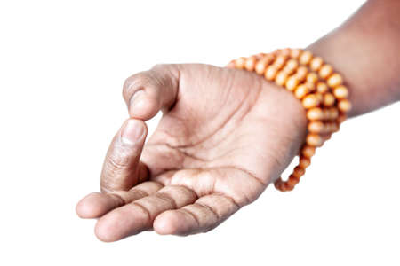 Hand in jnana or dhyana mudra with japa mala by Indian man isolated at white background. Gesture of consciousness and knowledge. Free space for your textの写真素材