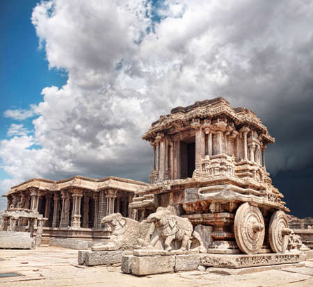 Stone chariot in courtyard of Vittala Temple at blue overcast sky in Hampi, Karnataka, Indiaの写真素材