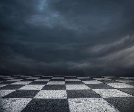 Chess floor and dramatic overcast sky premade backgroundの写真素材