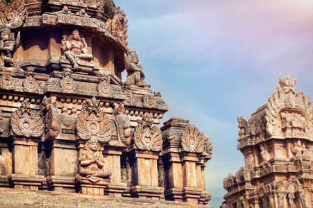 Ancient Hindu temple with deities and mythological creatures at blue sky in Hampi, Karnataka, India