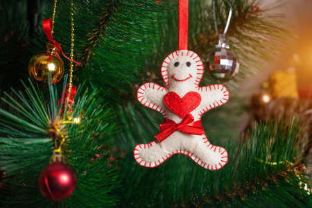 Christmas tree with gingerbread man from felt with red heard and red bow