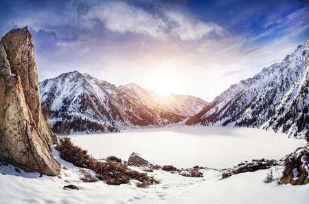Big Almaty Lake in snowy mountains at sunrise in Kazakhstanの写真素材
