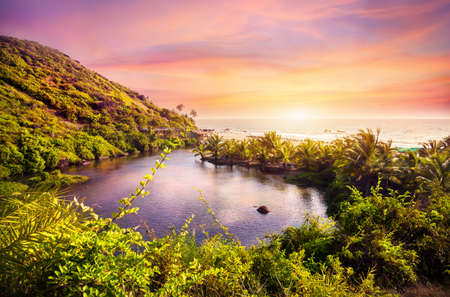 Tropical view to the Sweet Lake on Arambol beach at purple sky in Goa, Indiaの写真素材