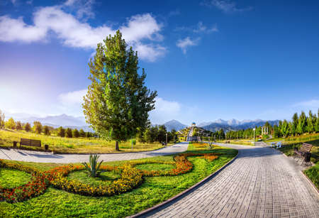 Flower garden and road in the park of first president Nursultan Nazarbayev at mountains in Almaty, Kazakhstanの写真素材