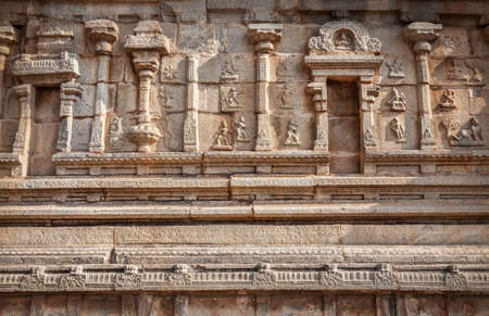 Ancient carved wall with hindu deities in Hazara Rama Jain Temple, Hampi, Karnataka, India