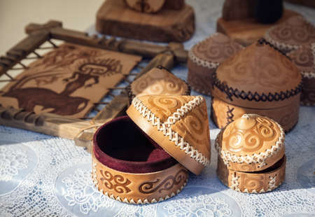 Ethnic yurt house souvenir and leather pictures in the market at Nauryz celebration in Almaty,...